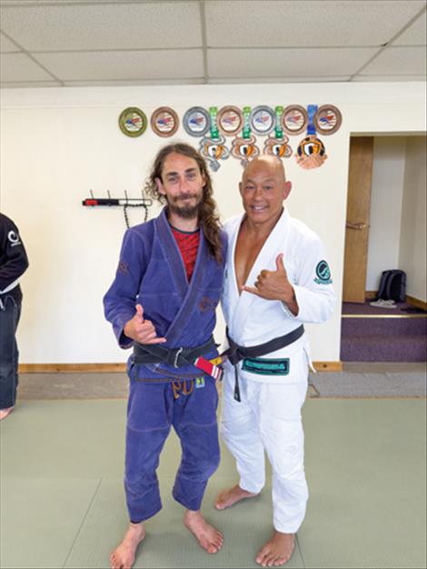 Coach Owen and Egan Inoue pose for a photo after the surprise promotion and seminar.