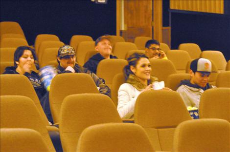 Julia Lozano and Jesse Shepard watch a film in the new seats at the Entertainer Theater in Ronan. 