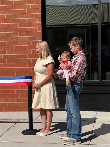 Dave Stipe’s grandson, Brandt, cuts the ribbon for the new Lake County Courthouse annex named for his grandfather as Stipe’s daughter Taylor assists and Commissioner Bill Barron holds the ribbon.