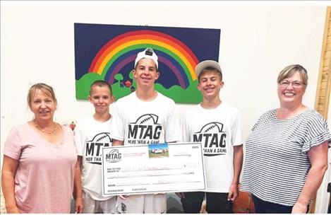 Director of CASA/Youth Connection Ann Marie McNeel, Trafford Cox, Case Cox, Ry Rasmussen and Youth Connection Coordinator Leah Brown pose for a photo following a youth-organized donation.