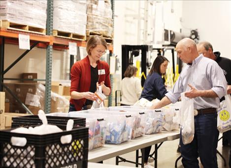Governor Gianforte helps serve meal packs at Helena Food Share.