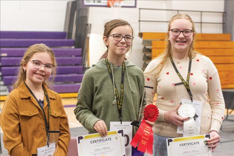 first, second and third place spelling bee winners Huber, Aubree Blevins and Addison Hogue pose for a photo after the competiton.