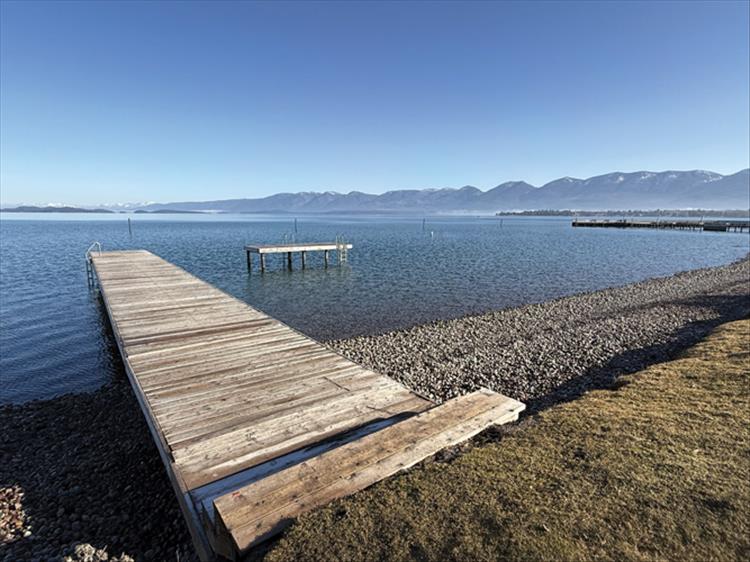 Summer goddard / valley journal photo Sun shines on a dock pointing out into Polson Bay, a harbinger of warmer days ahead.