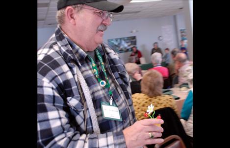 Len Dubuque returns to his seat with a door prize he won at the RSVP luncheon, held to honor volunteers