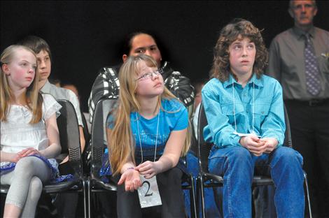 Participants watch as competitors step up to the microphone.