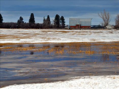 Fields of standing water are a common sight around the county as warming temperatures melt surface snow.