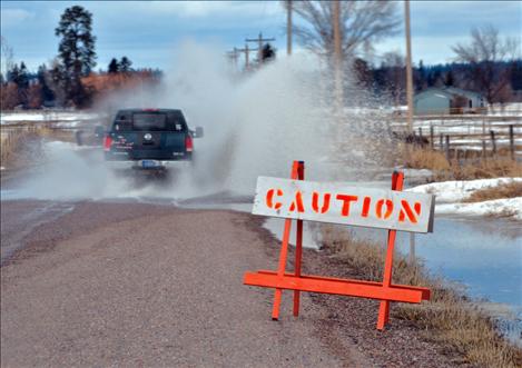 County road workers are marking road hazards, such as running water or deep potholes. Signs were up along North Foothills Road Friday afternoon.