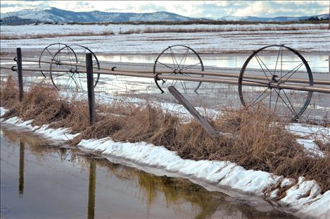 As gullies and barrow ditches fill with water, drivers are urged to use caution as snowmelt can quickly cover the roadway.