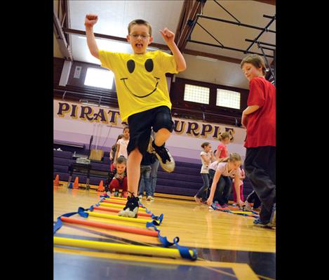 Justin Soderquist his happy to test his skill through a colorful agility ladder. 