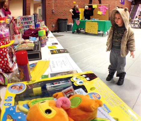 Tristan Butler longingly stares at the bingo prize table Friday night at Linderman Gym.