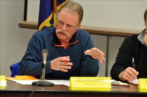 Lake County Planning Board Chair Bob Kormann talks with disgruntled citizens about the county’s zoning map. 