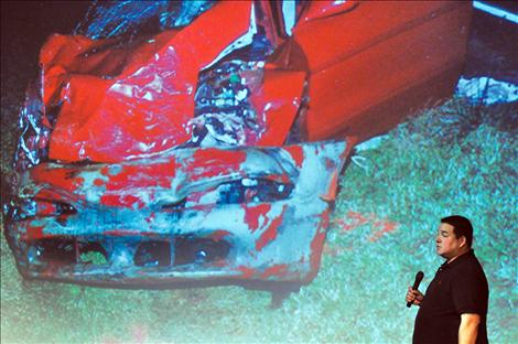 Chris Sandy shows photos of the crash site where he killed two people in a drunken driving accident in 2000. The court requires him to return to the crash once every year. 