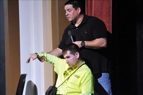 Chris Sandy, convicted of a drunken driving accident in 2000, and Eric Krug, who is bound to a wheelchair because of a drunken driving accident, talk with students in Ronan about consequences.