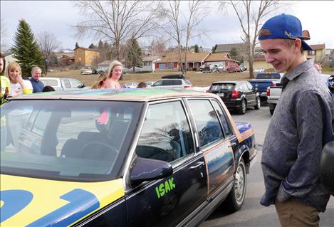 Polson High School senior, Isak Petersen, smiles following the unveiling of his winning car art design,“Hometown Scenery.”