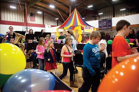 Children play musical chairs accompanied by live music performed by the Polson High School Pep Band.