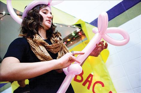 Tessa Nunlist shapes balloons at the Winter Carnival Sunday, March  22 at Polson High School.