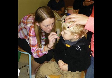 Students facepaint to raise funds for their class.