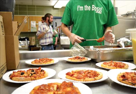 Kid’s Co-op member Stephen Roberts calls himself “the master pizza maker" at the Winter Carnival.