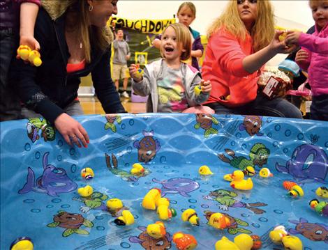Floating rubber ducks provide entertainment for young children.