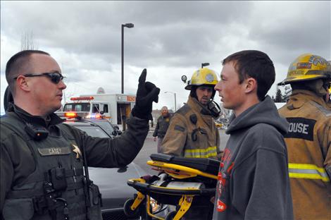 Ronan student Jesse Melton portrays a driver undergoing a field sobriety test during the reenactment.