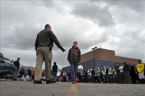 Ronan student Jesse Melton portrays a driver undergoing a field sobriety test during the reenactment.