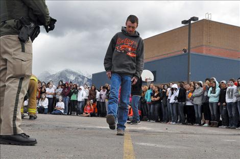 Ronan student Jesse Melton portrays a driver undergoing a field sobriety test during the reenactment.