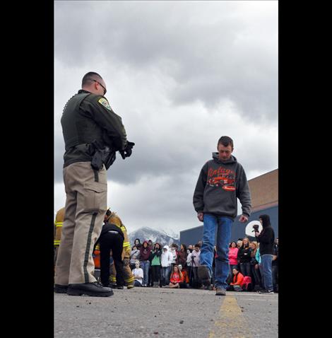 Ronan student Jesse Melton portrays a driver undergoing a field sobriety test during the reenactment.