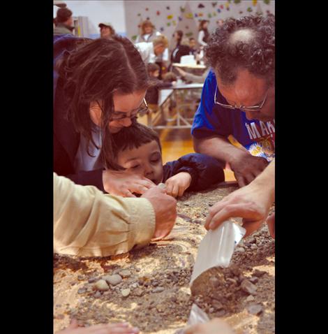 Jennifer, Robert, and David Broughton sift through rocks in search of gemstones. 