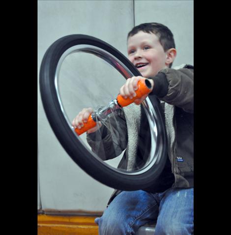 Haysen Hakes learns about physics using a bicycle wheel.