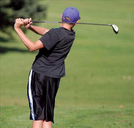 Alex Salois practices at the driving range during practice after school.