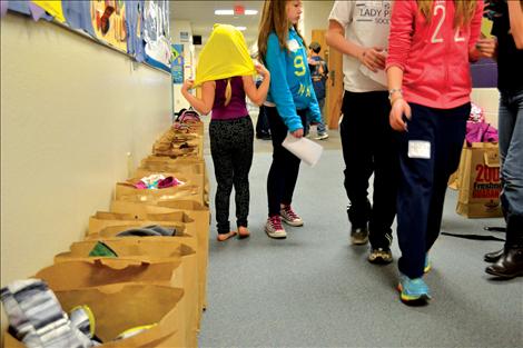 Each student is assigned a bag for their belongings and creations. The bags line the hallway as students make their way to class.