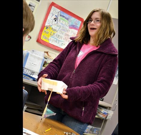 Mesa McKee explains how her paper sailboat is actually a tool to help a left-handed person paint without smearing a wet canvas.