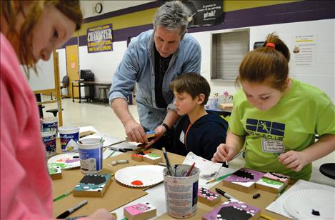 Mike Lemm teaches students how to paint Monsters on wooden blocks.
