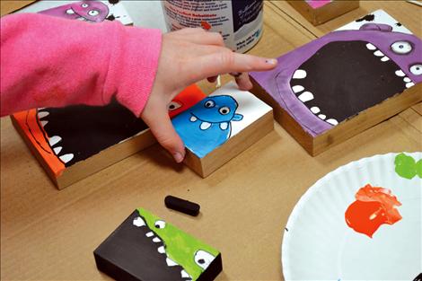 Mike Lemm teaches students how to paint Monsters on wooden blocks.