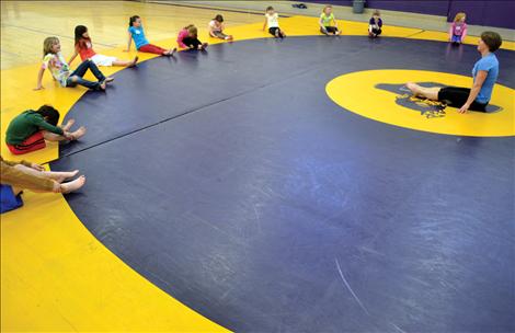 Children stretch before the learning to tumble.