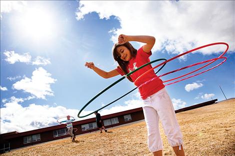 Myanna Taylor twirls three hula hoops at Saturday's Kids Create art and motion workshop in Polson.