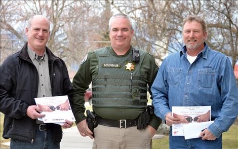 Gregg Perkins, left, and Robert Ragland, right, stand with Montana Highway Patrol Trooper Terry Rosenbaum
