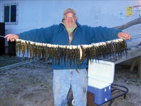 Dick Zimmer, the "MacMan," and a string of perch caught in Polson Bay.