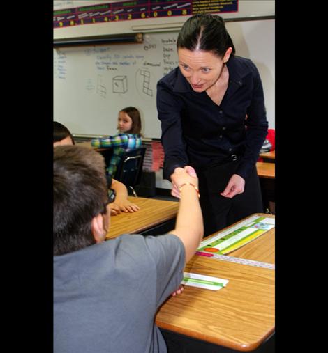 A student shakes the hand of Lt. Governor Angela McLean. 