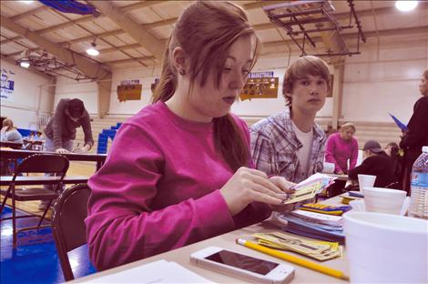 Cierra Dougherty and Karl Daniels play banker in a career fair at St. Ignatius High School. 