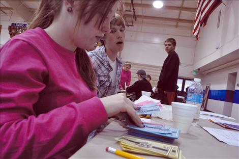 Cierra Dougherty and Karl Daniels play banker in a career fair at St. Ignatius High School. 