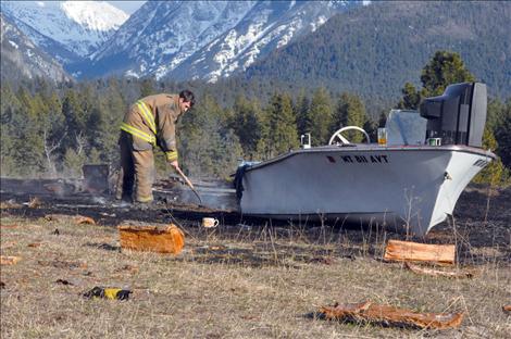 Ronan volunteer firefighter James Bays smothers hot spots left from a March 31 private burn in Ronan that grew out of control when the wind picked up.