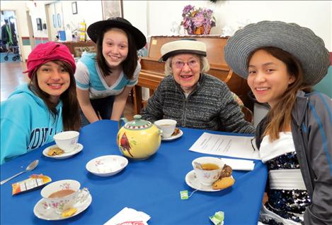 Polson Middle School eighth-grade students Janissa Taylor, Selicia Auld and Taryn Gravelle visit with Park Fisher, a resident at St. Joseph Assisted Living Center, during the 5th annual P.E.O. Tea Party.