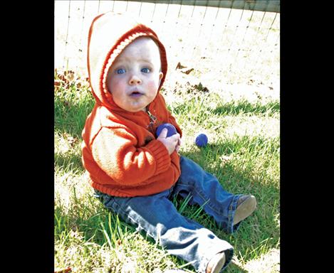 Randy Schmeusser, 8 months, grabs an Easter egg in Dayton at his first ever Easter egg hunt.  