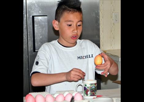 St. Ignatius Cub Scout David Michell checks out the results of a color he created.