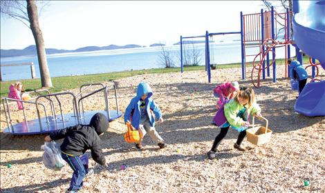 Young Easter egg hunters race to collect eggs at the Beta Easter Egg Hunt at Boettcher Park.in Polson.