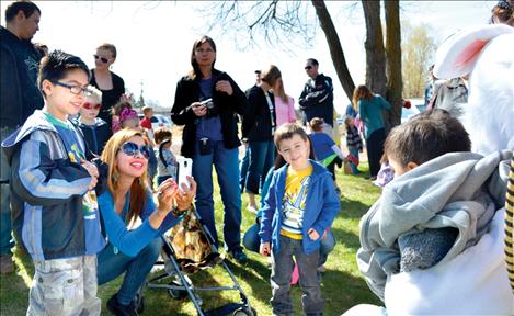 Families gather to take photographs with the Easter Bunny Saturday in Ronan’s Bockman Park