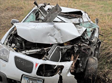 A Pontiac Vibe sustains severe damage after slamming into a tree near the Charlo turn on U.S. Highway 93. Many questions remain for investigators as the wrecked vehicle was discovered abandoned.