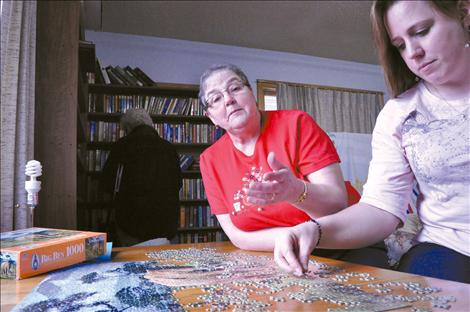 Linda Schoon works her way through a puzzle at the Ronan Senior Citizen’s Center with Andrea Lohf, the new director to fill Schoon's shoes.