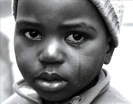 A big tear trickles down a young orphan’s cheek.